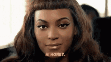 a close up of a woman 's face with the words `` hi honey '' written above her .