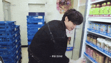 a man standing in front of a refrigerator that says " cold " on it