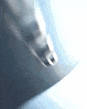 a blurred image of a person 's foot on a blue surface