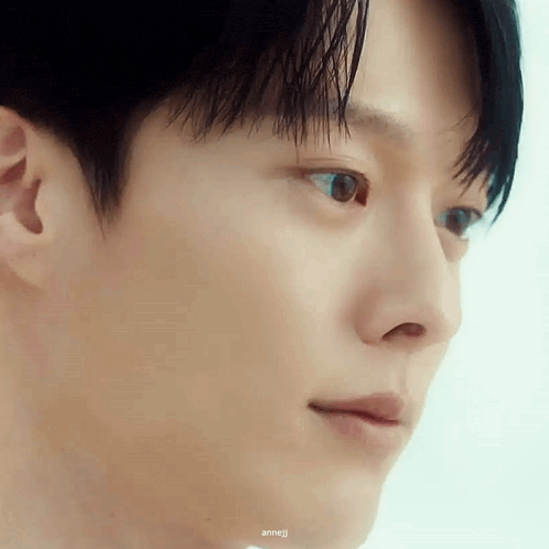 a close up of a man 's face with his eyes closed and his mouth open .