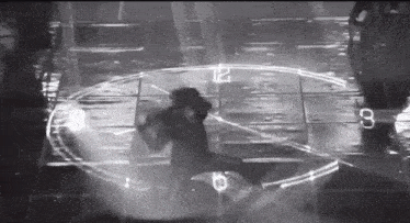 a black and white photo of a person dancing in front of a clock that says 12 on it