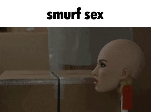 a man kissing a woman 's head with the words smurf sex above him