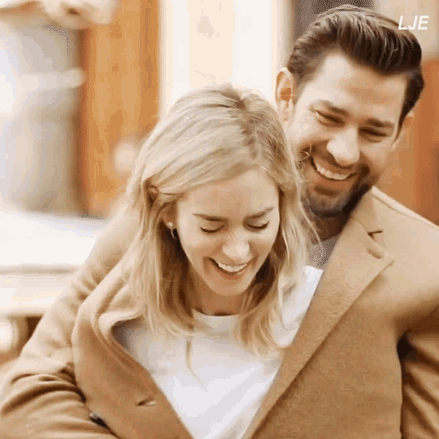 a man and a woman are hugging and smiling with the letters lje on the bottom