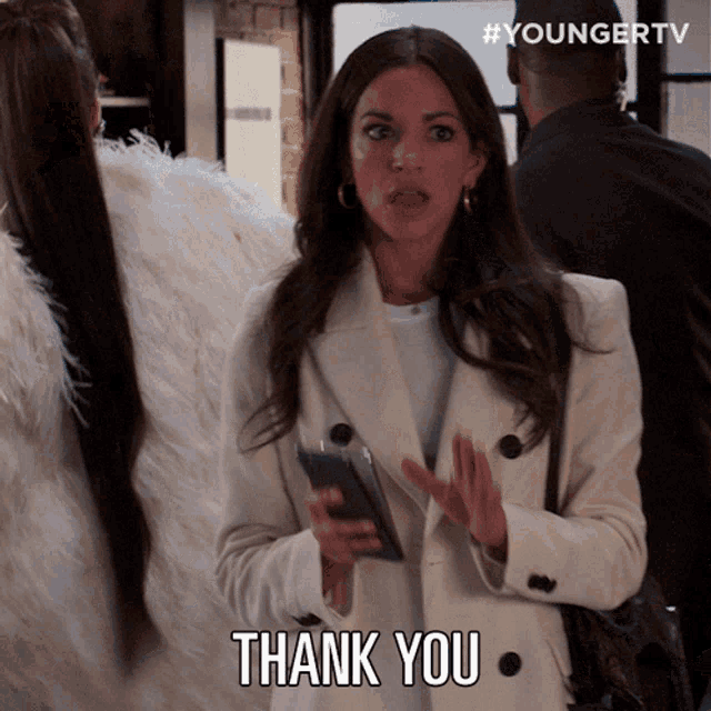 a woman in a white coat says thank you