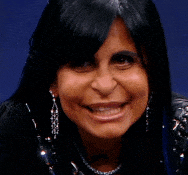 a close up of a woman 's face with a surprised look on her face