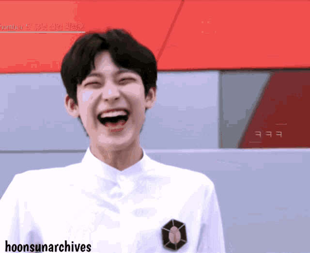 a young man laughs in front of a sign that says number 5
