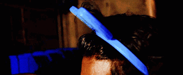 a man with a blue headband on his head is smoking a cigarette