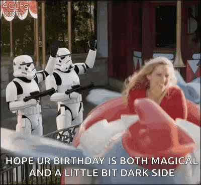 a woman is riding a roller coaster with stormtroopers .