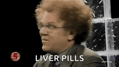 a man in a suit and tie is sitting in front of a window and talking about liver pills .