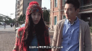 a man and a woman are standing next to each other and the woman is wearing a knitted hat