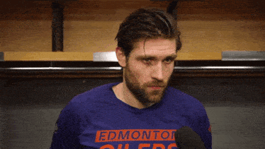 a man wearing a shirt that says edmonton oilers on it