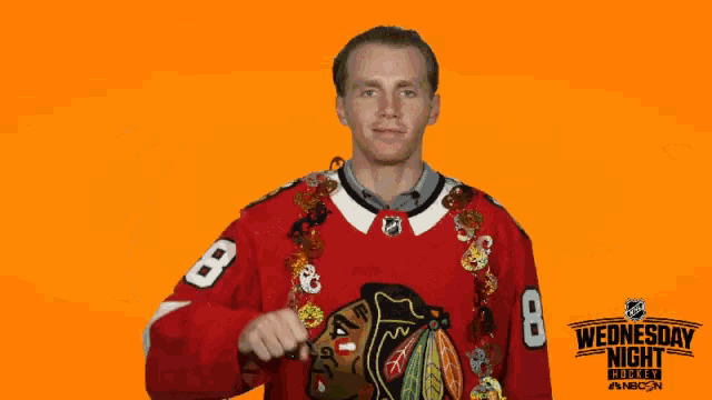 a hockey player is holding a trick or treat bucket in front of a wednesday night hockey sign