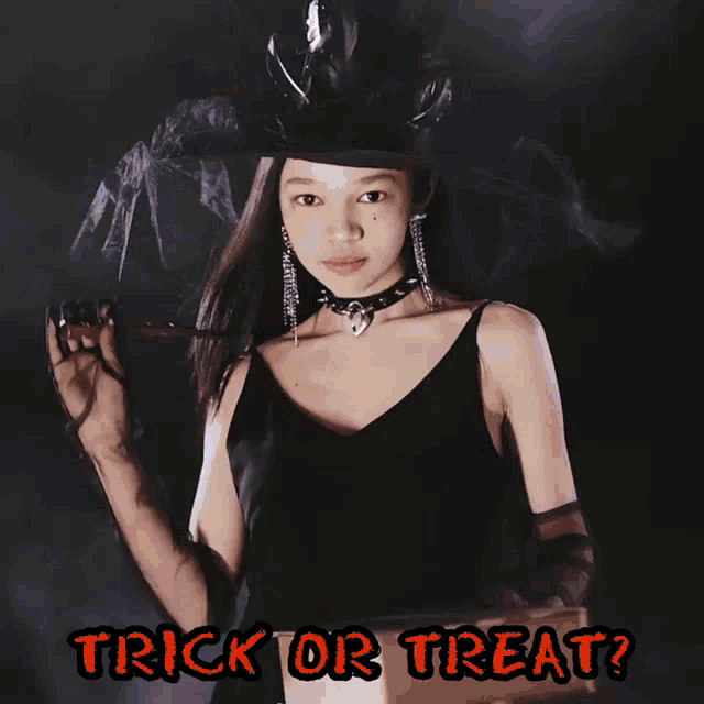 a girl in a witch costume is holding a flashlight and the words trick or treat are below her