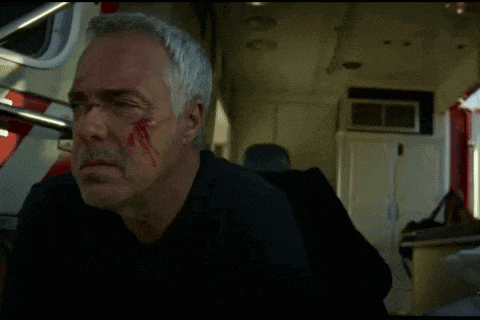 a man in an ambulance with a bloody face