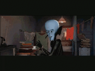 a cartoon character is wearing a black cape and smiling in a dark room