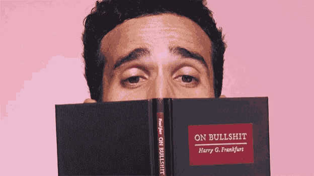 a man is holding a book called on bullshit