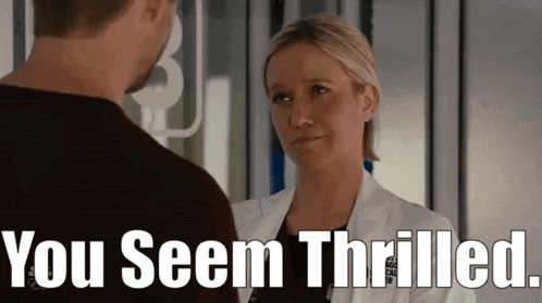 a woman in a lab coat talking to a man with the words you seem thrilled