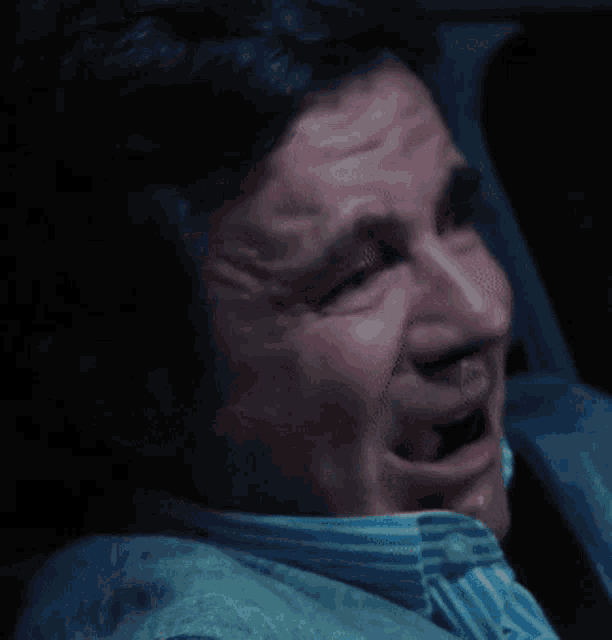 a man in a striped shirt is making a funny face