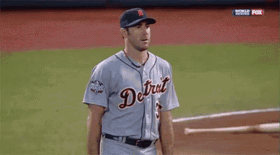 a man in a detroit baseball uniform is standing on a field .