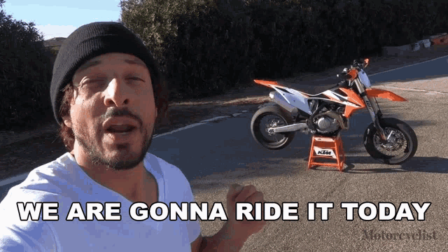 a man says we are gonna ride it today next to a motorcycle