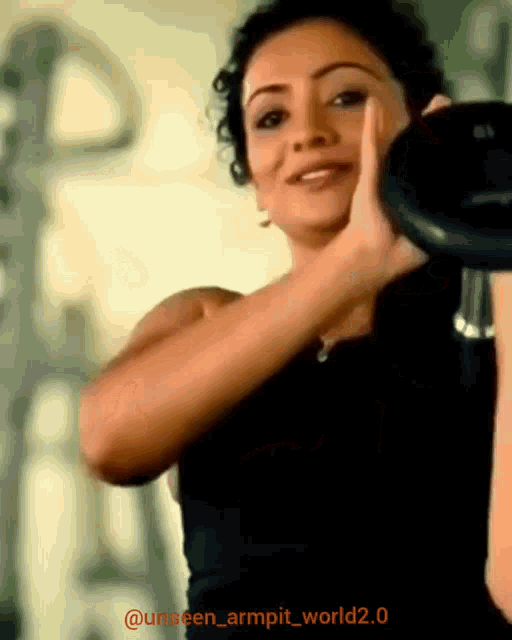 a woman lifting a dumbbell in a gym with the hashtag unseen_armpit_world2.0 on the bottom