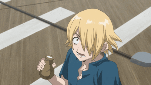 a boy with blonde hair is holding a small bottle