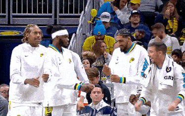 a group of basketball players with one wearing a jersey that says gay on it