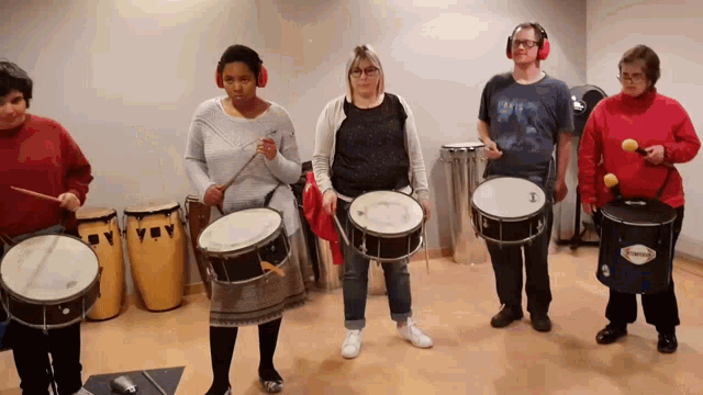 a group of people playing drums with one wearing a shirt that says ' levis ' on it