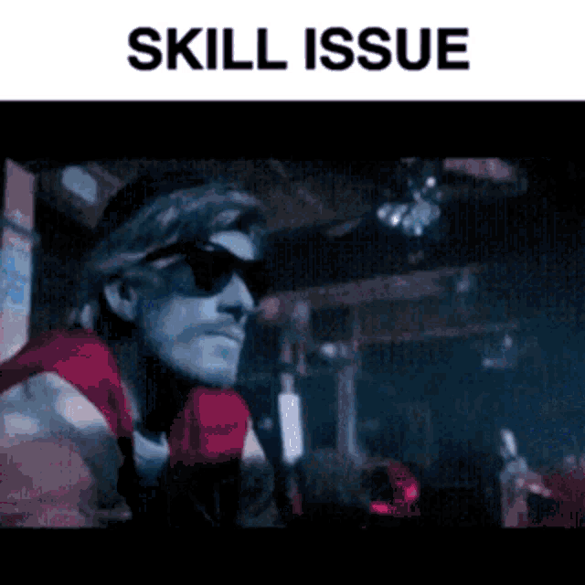 a man wearing sunglasses and a red and white shirt is sitting in a dark room under the words skill issue