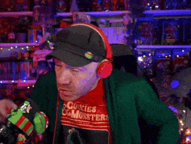 a man wearing headphones and a cookie monster shirt