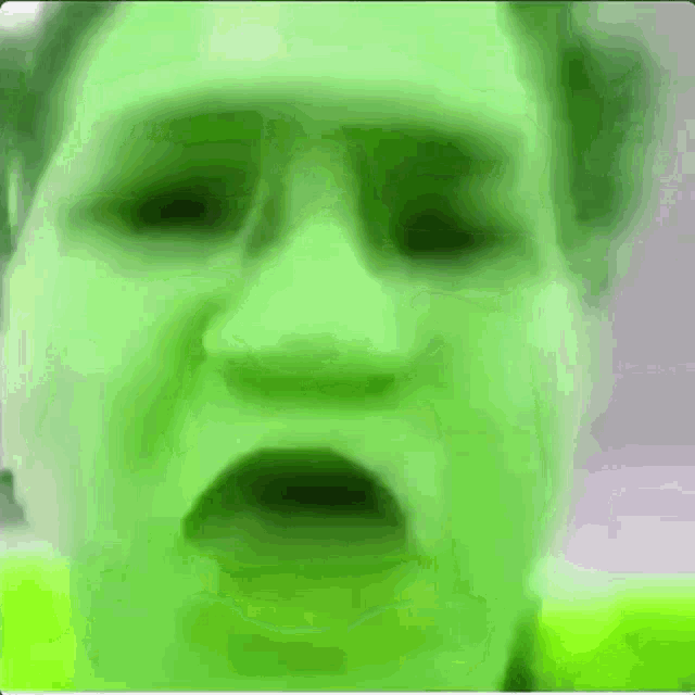 a close up of a person 's face with a green glow