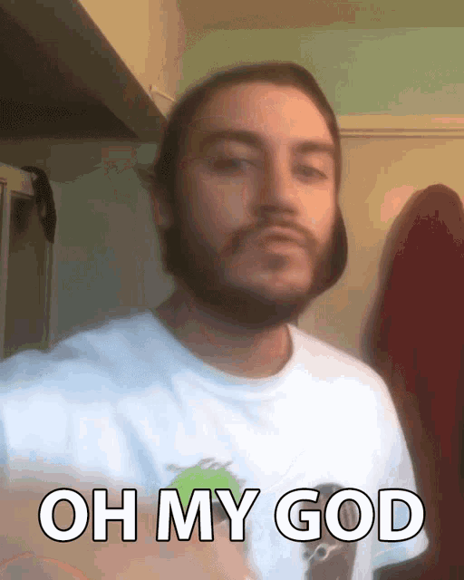 a man with a beard is wearing a white shirt that says oh my god on it