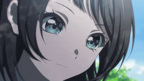 a girl with black hair and blue eyes looks at the camera