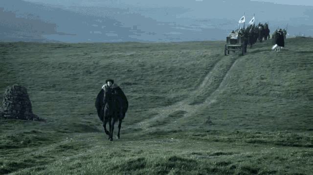 a man riding a horse on a grassy hillside