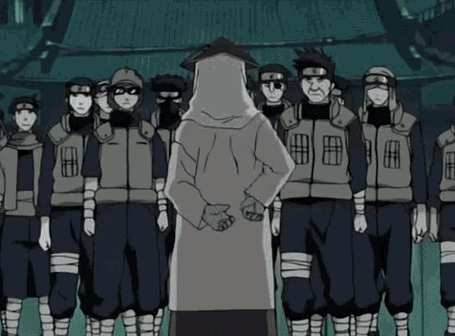 a man in a white robe is standing in front of a group of soldiers in a stadium .