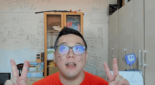 a man wearing glasses stands in front of a white board with chinese writing on it