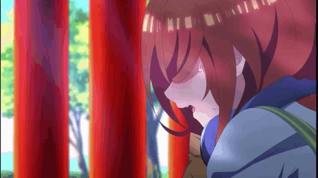 a girl with red hair is standing in front of a red pole