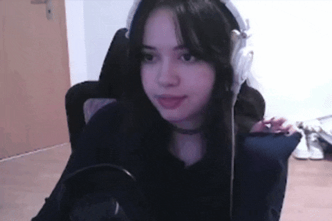 a girl wearing headphones is sitting in front of a microphone .