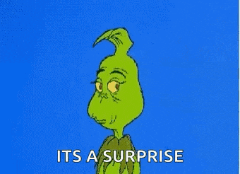 a cartoon of grinch with a surprised look on his face and a blue background .
