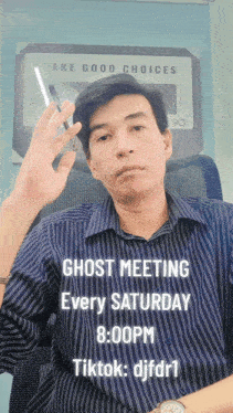 a man sitting in front of a sign that says ghost meeting every saturday at 8:00 pm