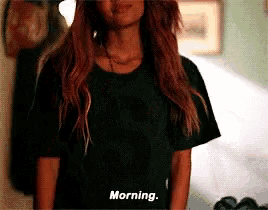 a woman wearing a black t-shirt that says morning