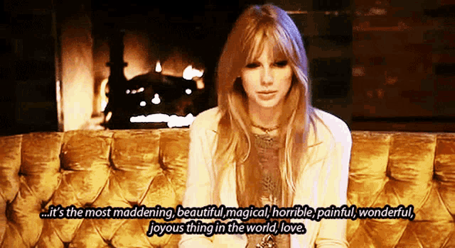 a woman is sitting in front of a fireplace and says it 's the most maddening beautiful magical horrible painful wonderful