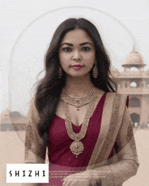 a woman wearing a necklace and earrings stands in front of a building and the word shizhi is on the bottom