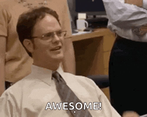 dwight schrute from the office is sitting in a chair and smiling .