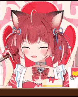 a red haired anime girl is sitting at a table with a microphone and a cake .