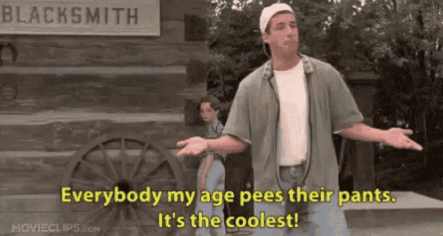 a man is standing in front of a sign that says `` everybody my age pees their pants .