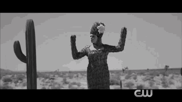 a black and white photo of a woman dressed as a cactus with the cw logo in the corner