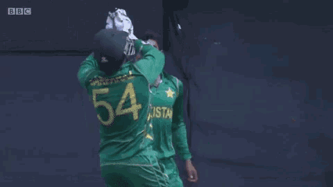 a group of cricket players wearing green uniforms with pakistan on the front