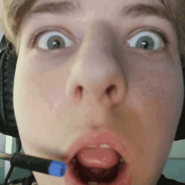 a close up of a person 's face with a microphone
