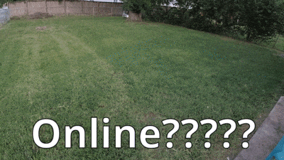 a man is riding a lawn mower in a grassy yard with the words online written below him